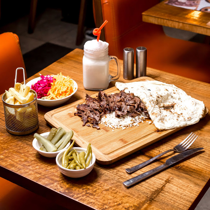 Turkish grilled meat served with rice, flatbread, fries, salad and ayran at Istanbul Village