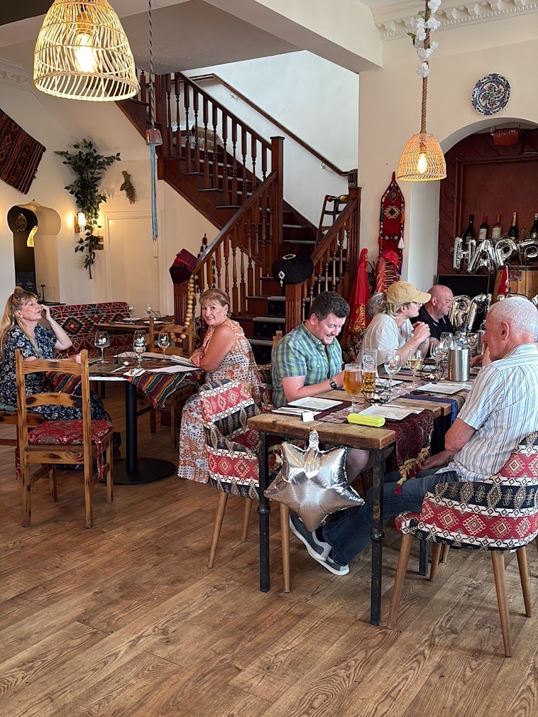 Guests dining in the cosy Turkish restaurant interior at Istanbul Village, Congleton